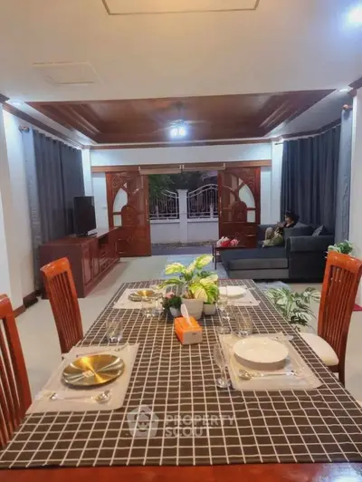 Spacious living room with elegant dining area and cozy seating, perfect for family gatherings.