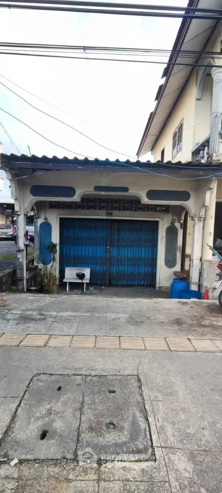 Charming vintage storefront with blue shutters and classic architectural details.