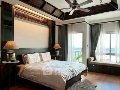Luxurious bedroom with elegant decor and stunning view from large window.