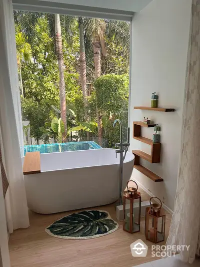 Luxurious bathroom with freestanding tub and lush garden view