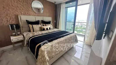 Luxurious bedroom with elegant decor and stunning city view from balcony.