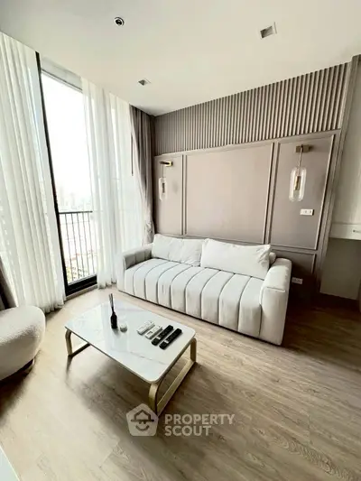 Modern living room with elegant decor and large windows offering city views