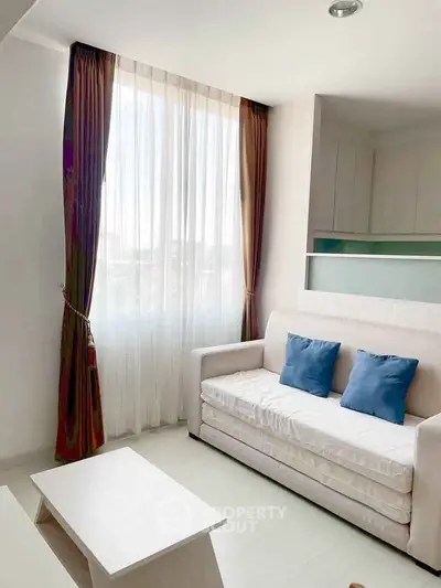 Bright and cozy living room with elegant curtains and comfortable sofa