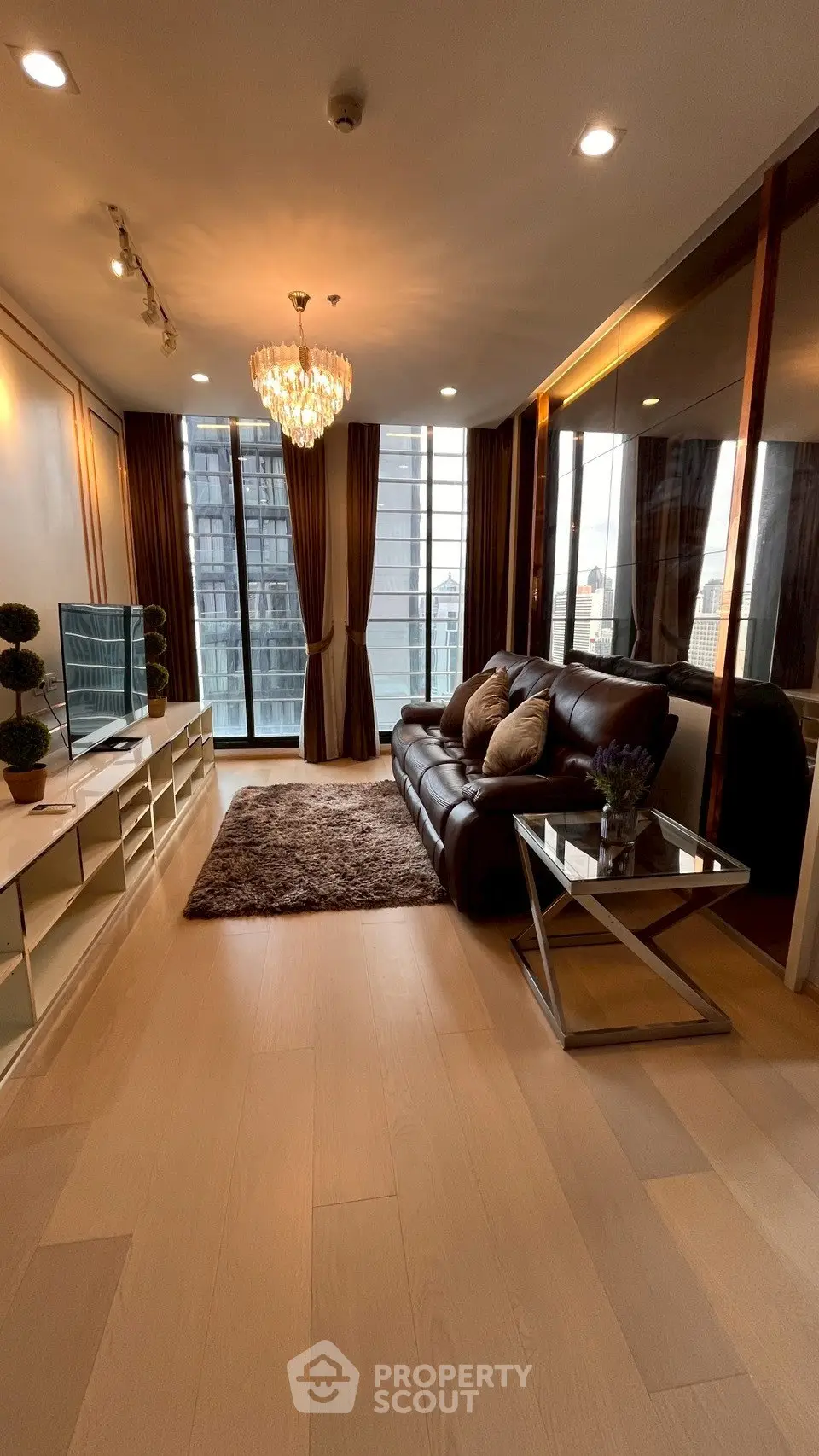 Luxurious living room with elegant chandelier and stunning city view
