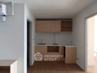 Modern kitchen with sleek cabinetry and open layout in a contemporary apartment.