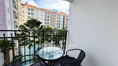 Charming balcony with pool view in modern apartment complex