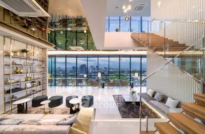 Luxurious modern living room with stunning city view and elegant staircase