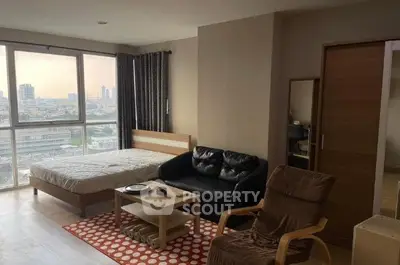Spacious studio apartment with city view, featuring cozy furniture and natural light.