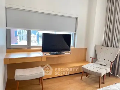 Modern living room with stylish furniture and city view window, perfect for urban living.