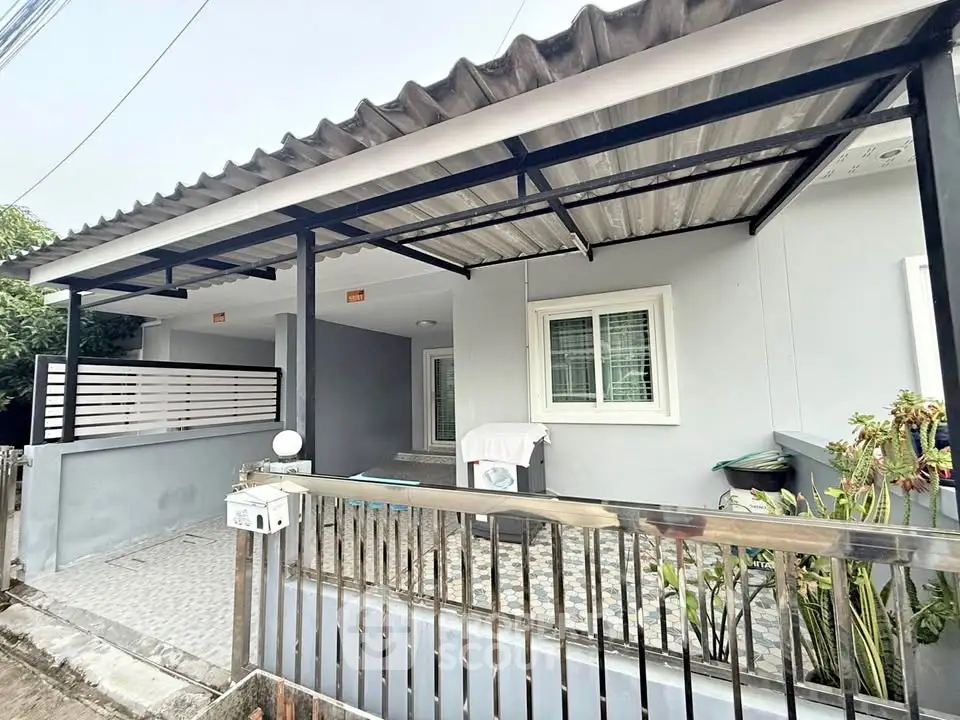 Charming single-story home with covered porch and modern exterior design.