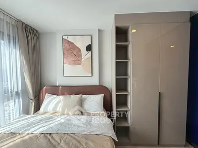 Modern bedroom with stylish decor and ample natural light