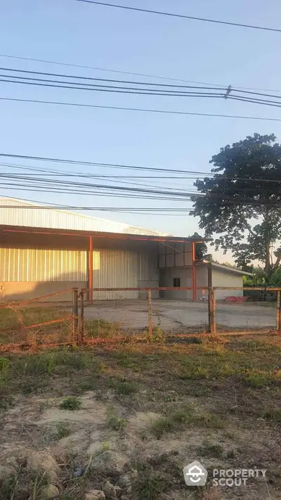 Spacious industrial warehouse with ample outdoor space and secure fencing