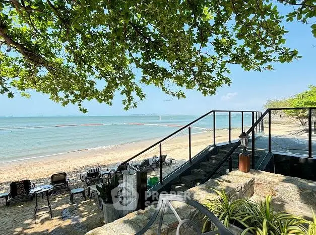 Stunning beachfront property with direct ocean access and lush greenery, perfect for serene living.