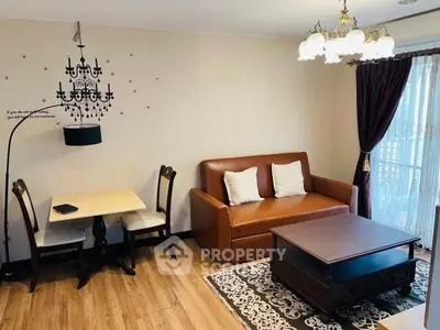 Charming living room with elegant chandelier, cozy sofa, and stylish dining area.