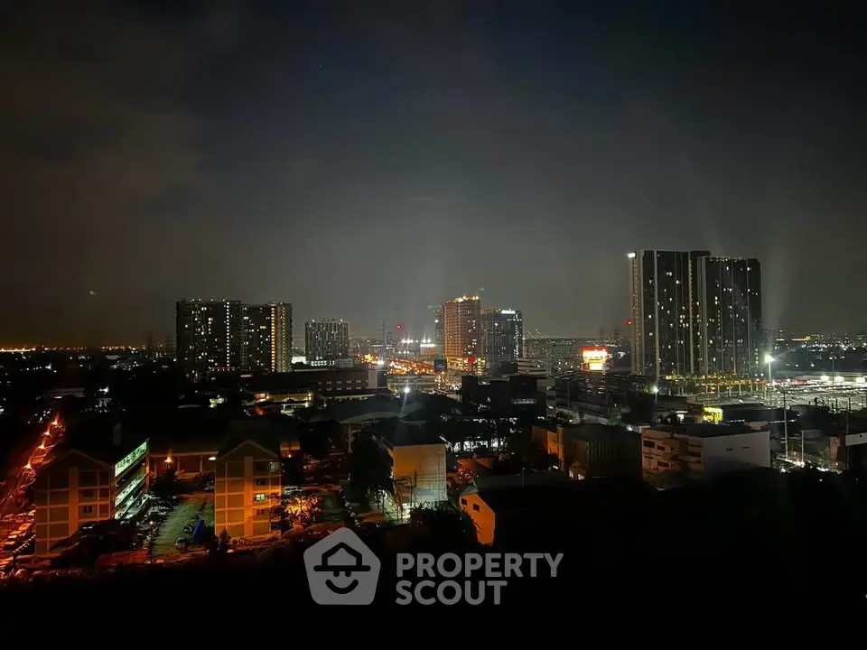 Stunning night view of city skyline with illuminated buildings and vibrant urban landscape.