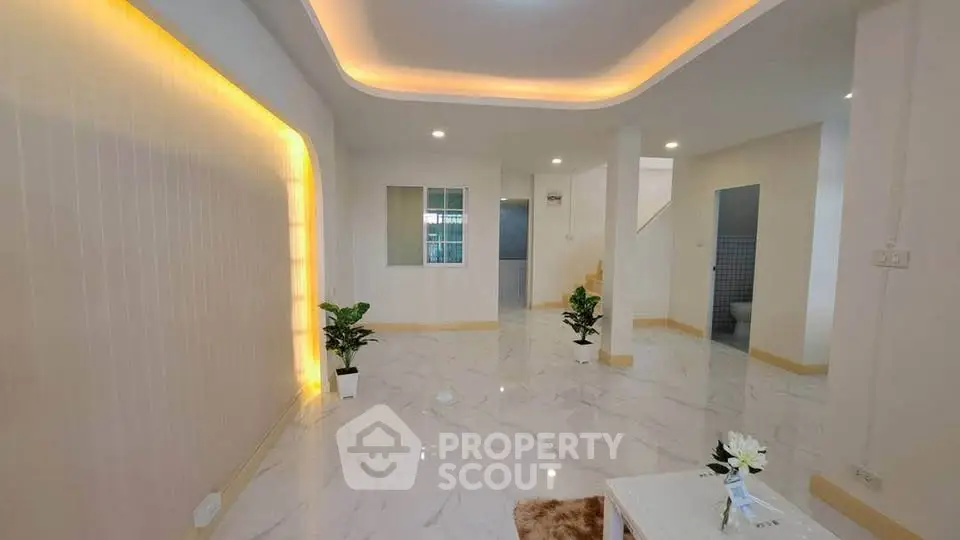 Spacious modern living room with elegant lighting and marble flooring