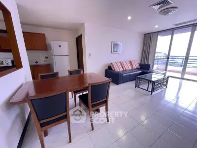 Spacious living room with modern furniture and balcony access in a stylish apartment.