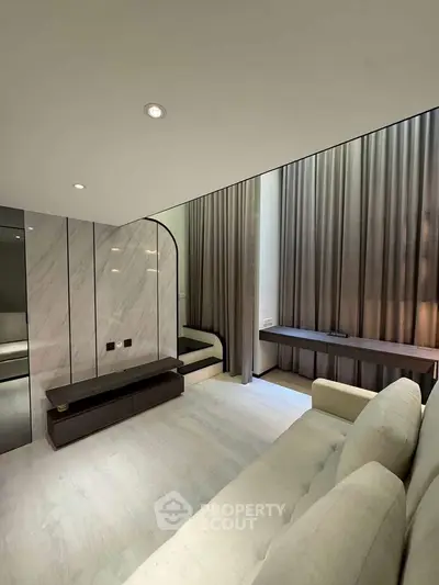 Modern living room with elegant design and floor-to-ceiling curtains