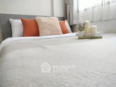 Cozy bedroom with plush pillows and soft lighting, perfect for relaxation.