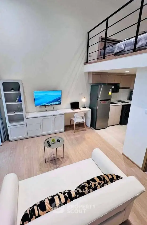 Modern loft apartment with open living area, stylish kitchen, and cozy mezzanine bedroom.