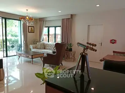 Spacious living room with elegant decor and garden view, perfect for relaxation and entertaining.