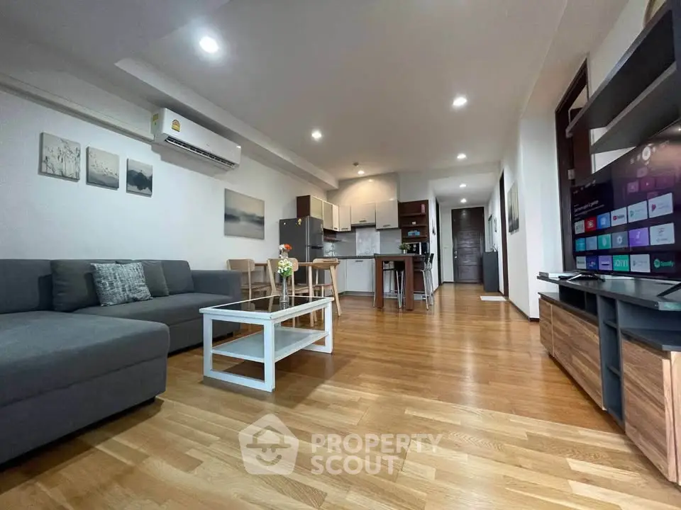 Spacious modern living room with open kitchen layout and stylish decor