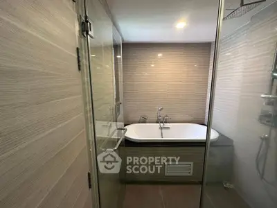 Modern bathroom with glass shower and sleek bathtub design