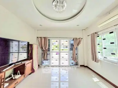 Spacious living room with modern decor and large windows for natural light.