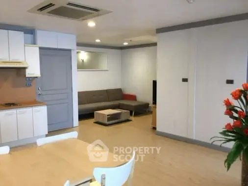 Spacious open-plan living room with modern furniture and wooden flooring