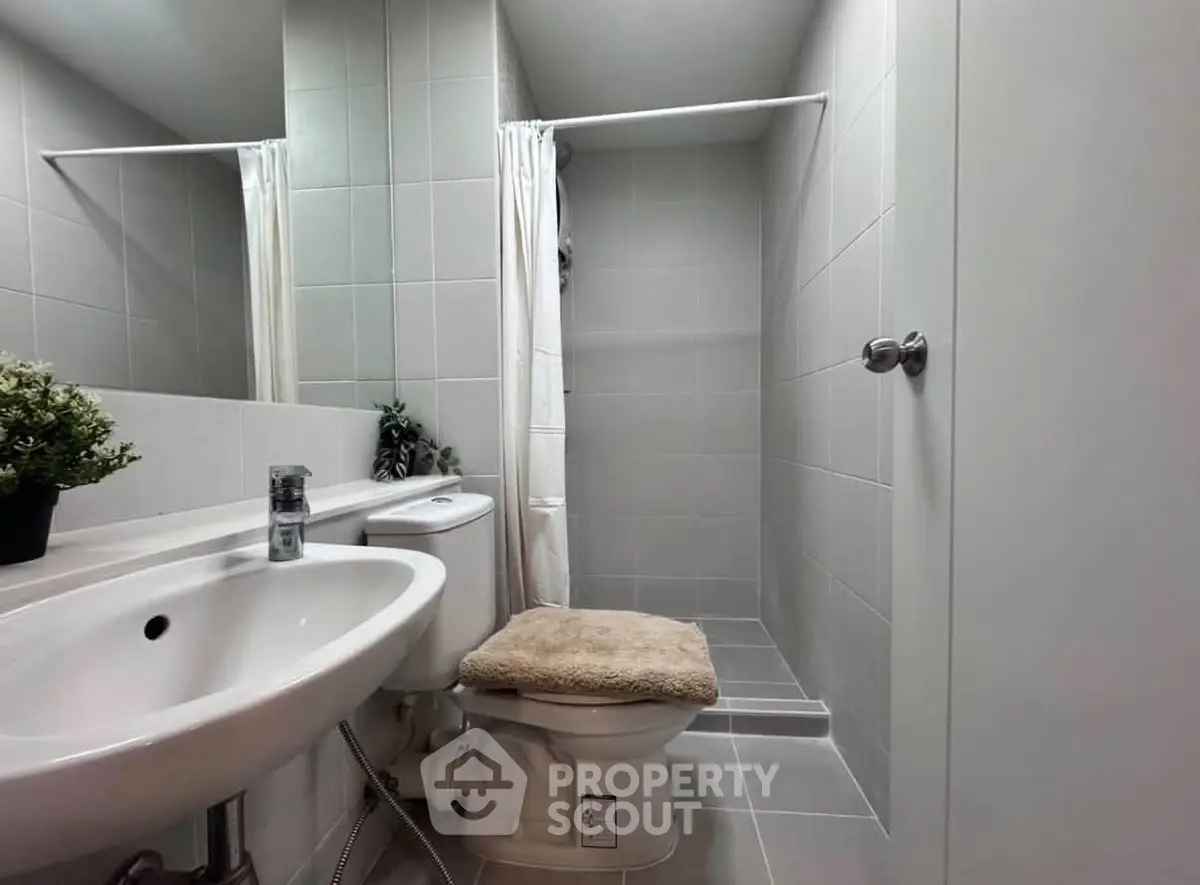Modern bathroom with sleek fixtures and a walk-in shower, perfect for contemporary living.