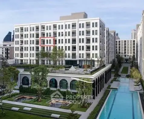 Luxurious modern apartment complex with pool and landscaped gardens.