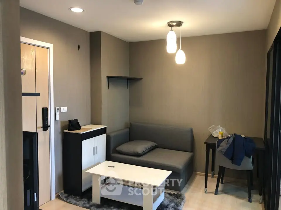 Cozy living room with modern furniture and warm lighting, perfect for relaxation.