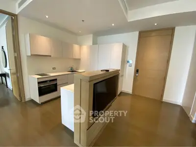 Modern kitchen with sleek cabinetry and integrated appliances in luxury apartment