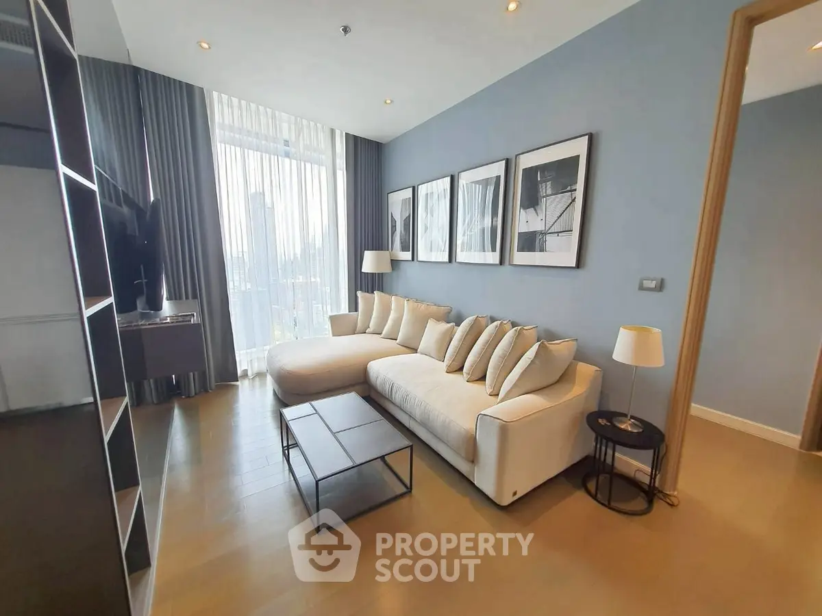 Modern living room with stylish decor and large windows offering city views