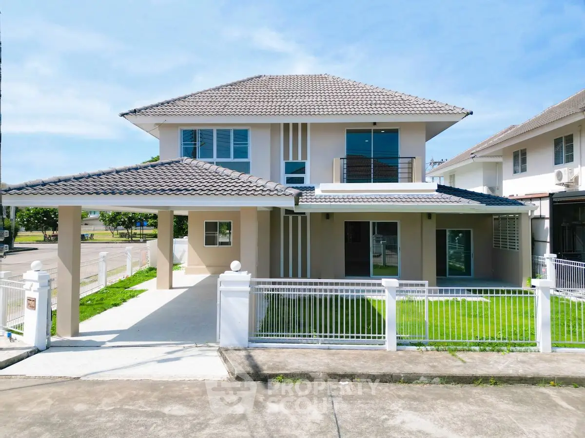 Modern two-story house with spacious driveway and manicured lawn