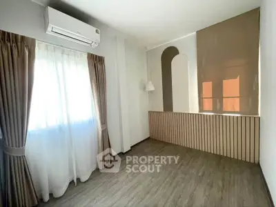 Spacious room with elegant curtains and modern air conditioning unit, perfect for a cozy living space.