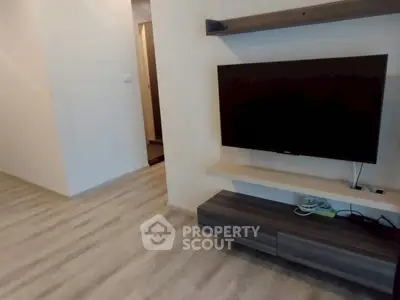Modern living room with sleek TV setup and stylish wooden flooring