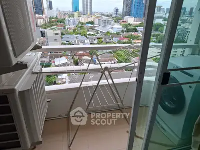 High-rise apartment balcony with city view and laundry area