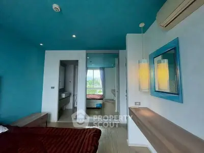 Modern bedroom with blue accents and mirrored closet doors