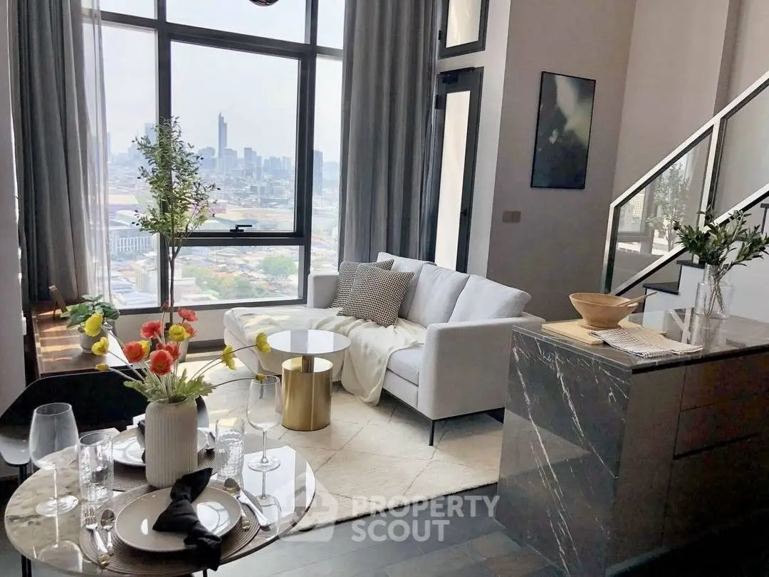 Modern living room with city view, stylish decor, and elegant furniture in a high-rise apartment.