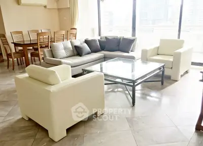 Spacious living room with modern furniture and city view, perfect for urban living.