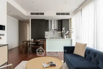 Modern open-plan living room with sleek kitchen and stylish furnishings