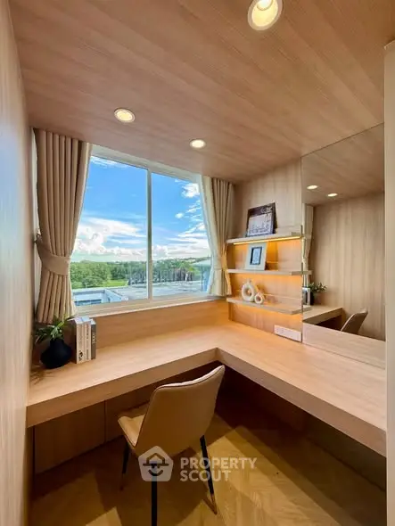 Modern study room with large window and scenic view, featuring sleek wooden desk and comfortable chair.