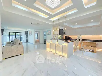 Luxurious open-plan living room with modern kitchen and elegant lighting