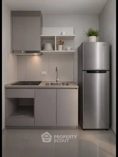 Modern compact kitchen with sleek cabinets and stainless steel fridge