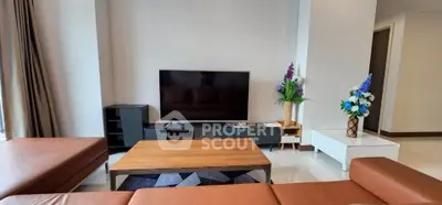 Modern living room with sleek furniture and large TV, perfect for relaxation.