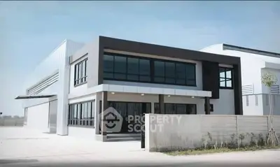 Modern industrial building with sleek design and large windows, ideal for commercial use.