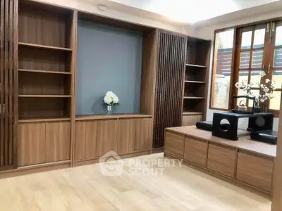 Elegant living room with wooden built-in shelves and modern decor