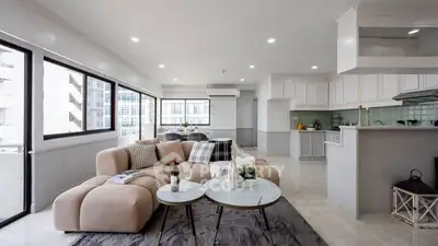 Spacious modern living room with open kitchen and large windows