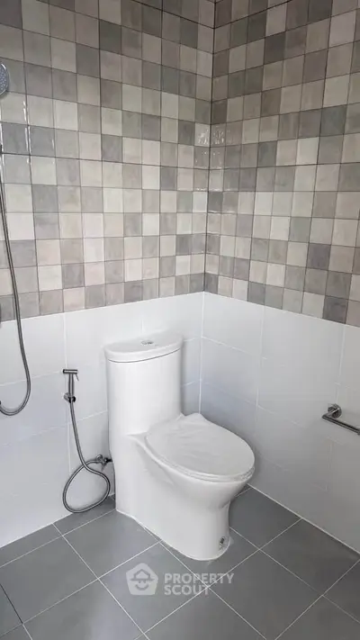 Modern bathroom with sleek tiles and a clean toilet design